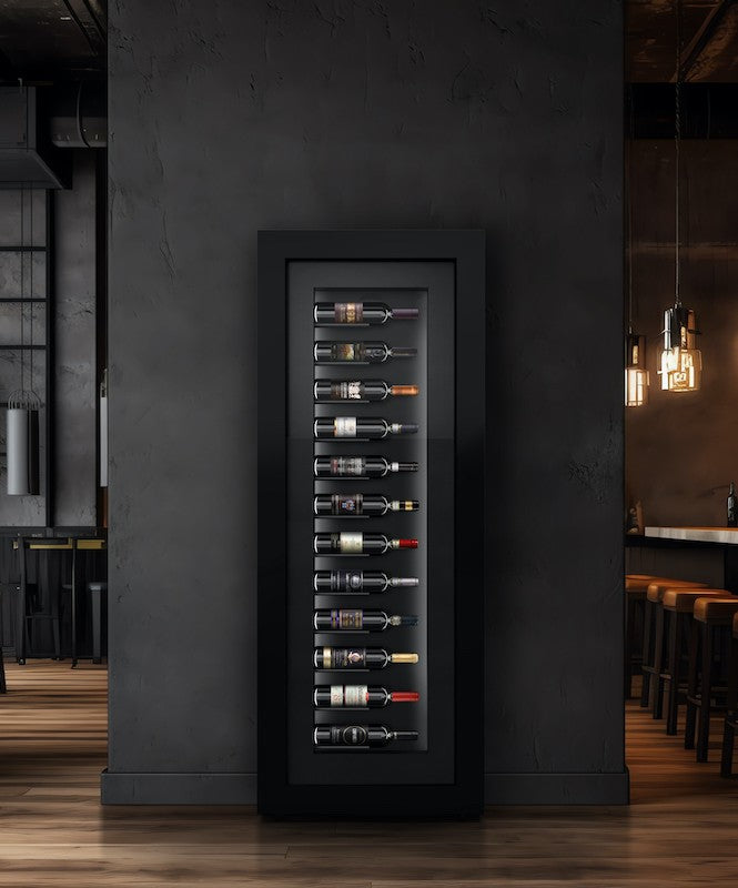 A tall, rectangular black wine cabinet  containing 12 horizontal wine bottles mounted on a black wall in a restaurant setting