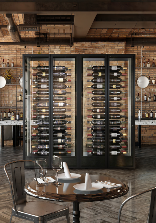 2 wine cabinets side by side with glass doors on both sides in a restaurant with a brown stone wall and grey wooden floor in a herringbone pattern