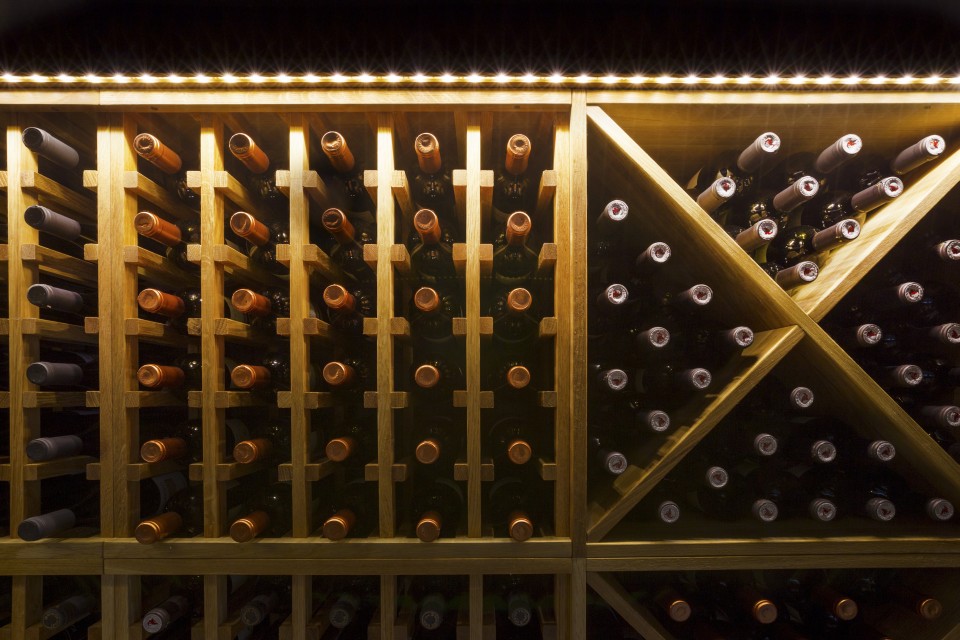 Bottles of wine in a UK wine wall display cabinet